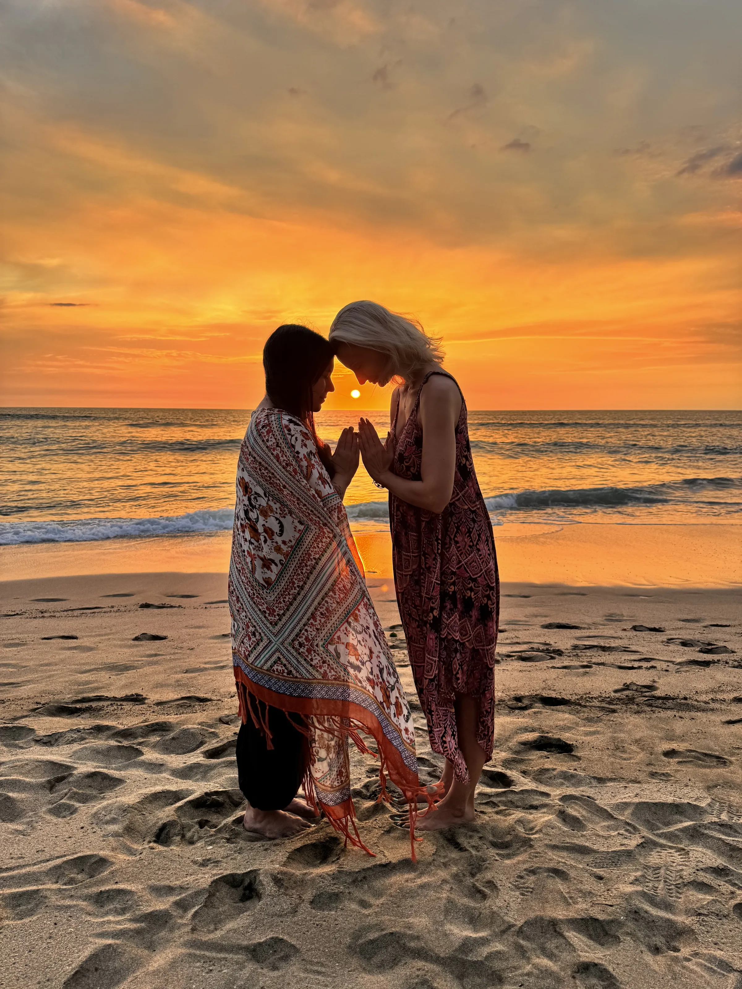 Two women in ceremony at sunset on Playa Junquillal