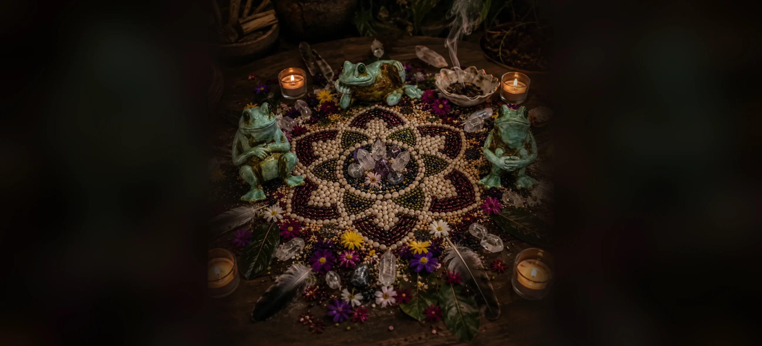 Ceremony altar with seed mandala, frogs, crystals and candlelight