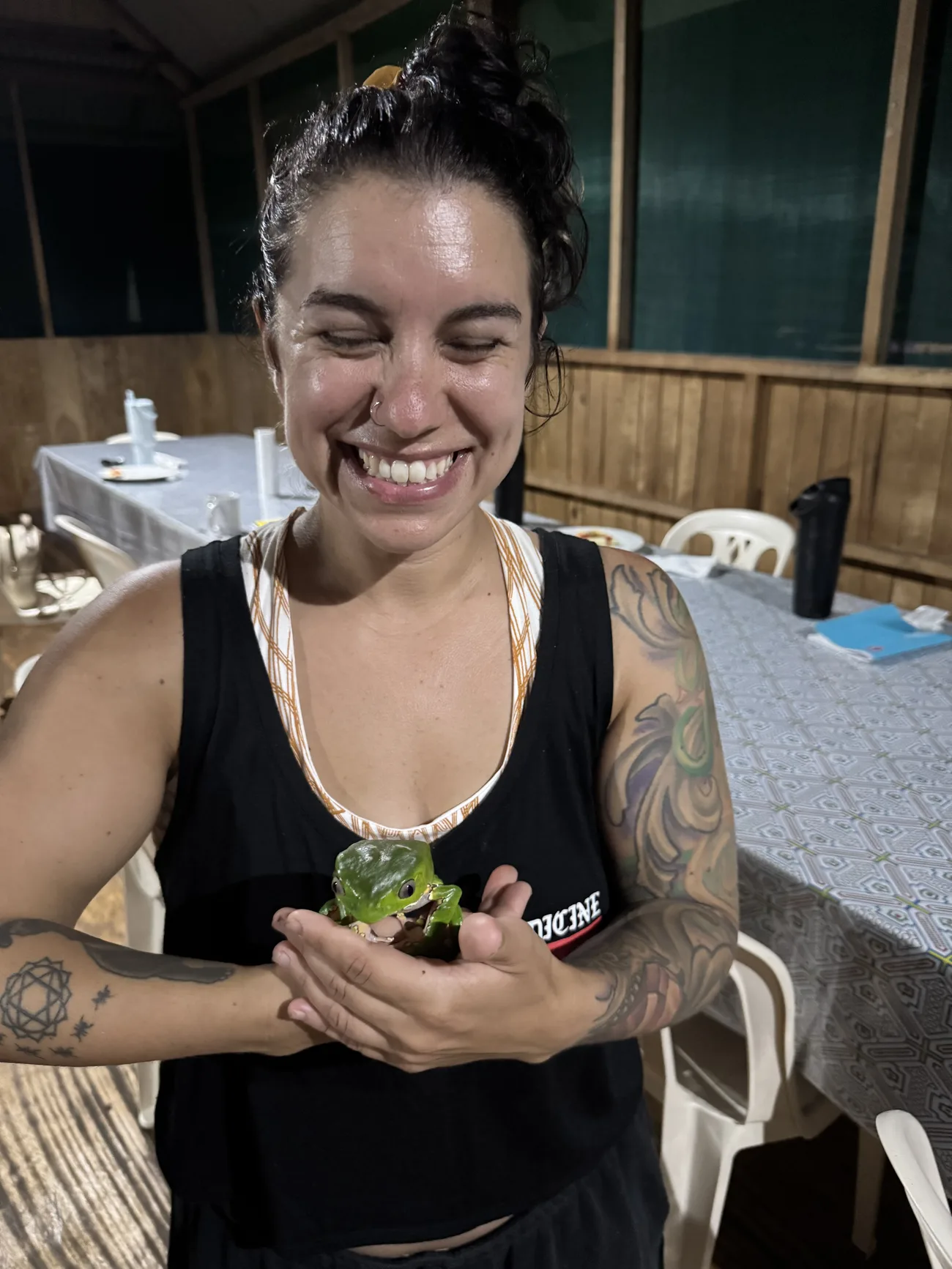 McKenzie smiling with the giant monkey frog in the Amazon