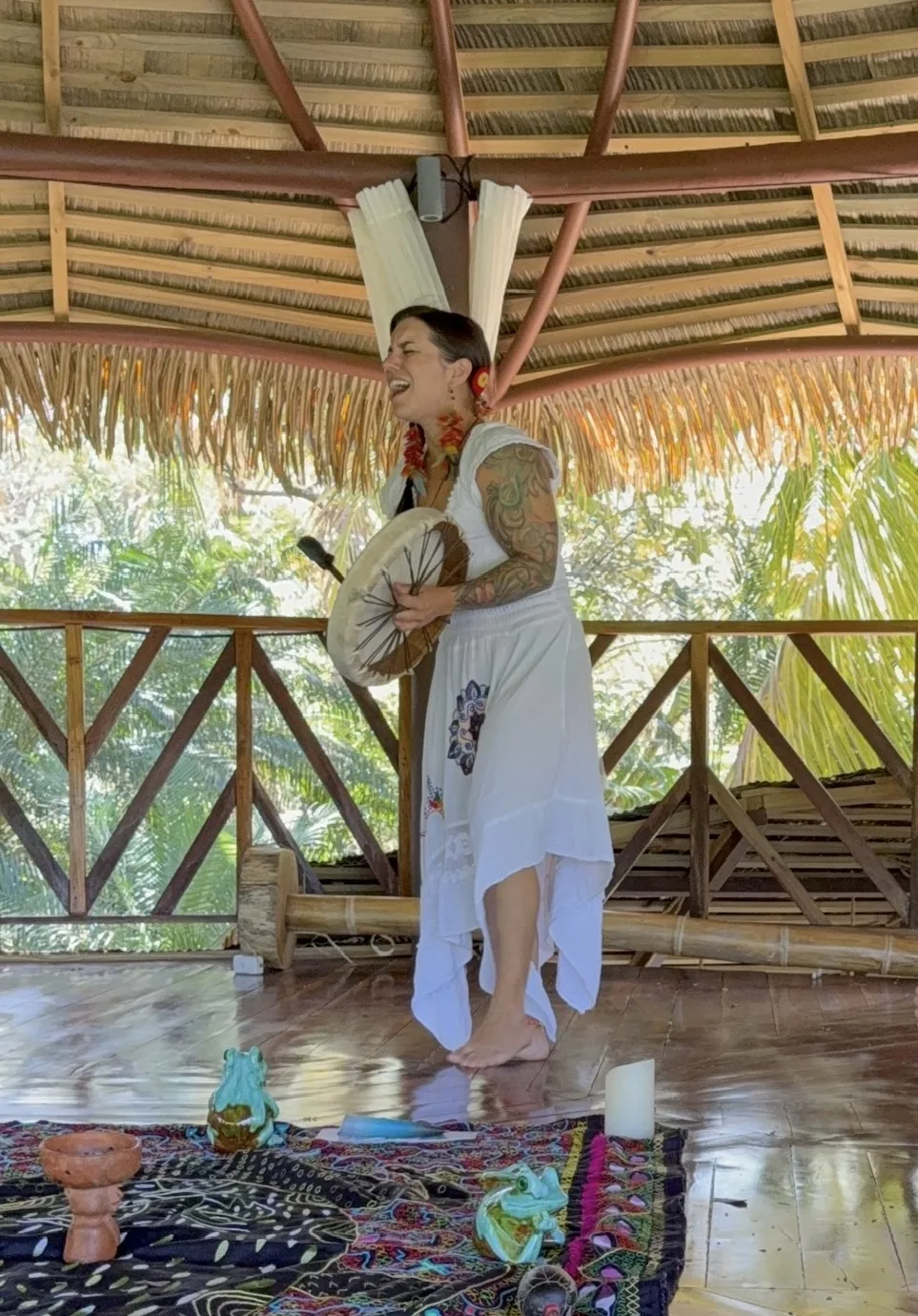 McKenzie singing with her drum in the shala