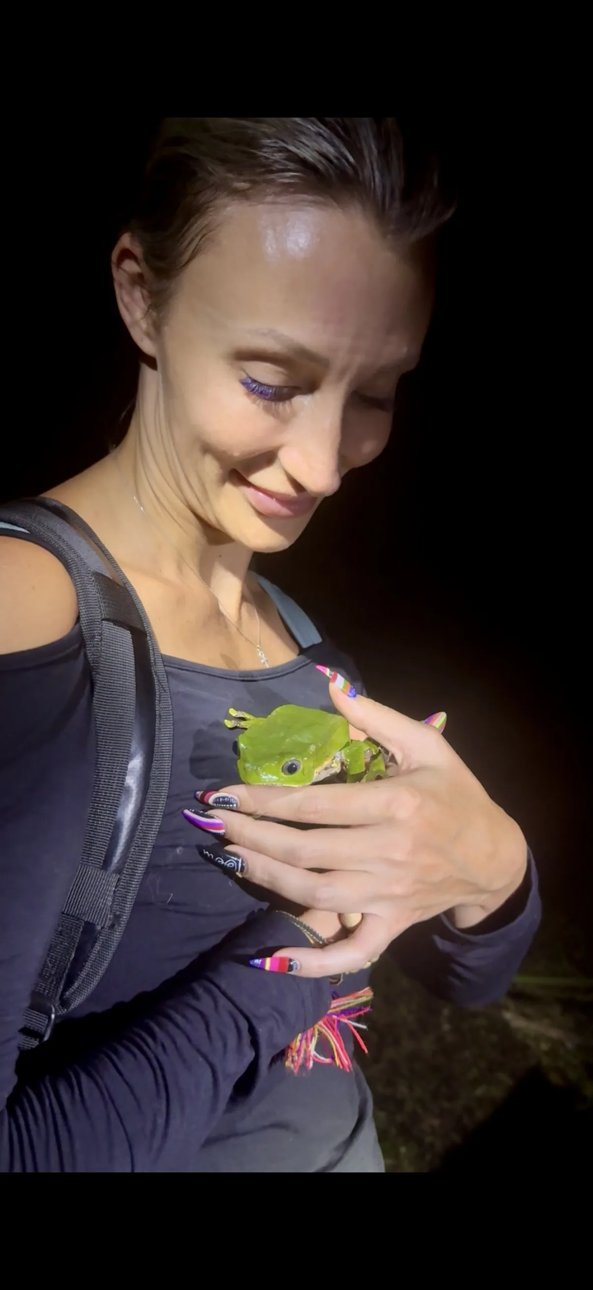 Susan holding the giant monkey frog at night in the Amazon